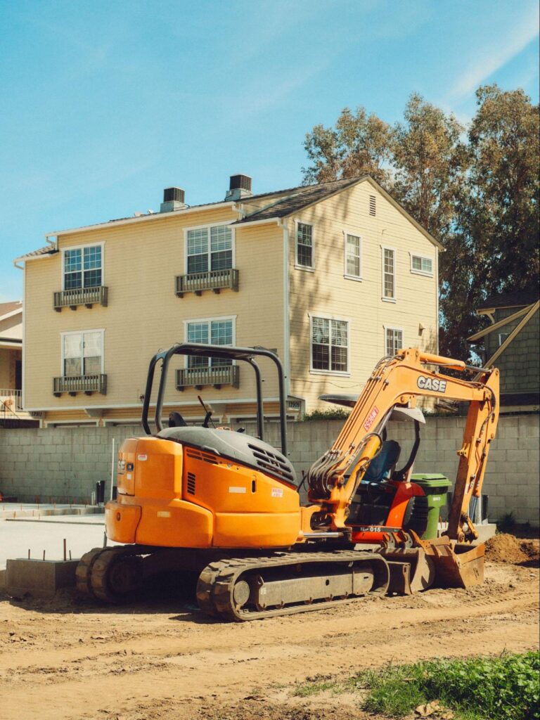 Compact excavator preparing a residential site for septic system installation in Prescott, AZ.