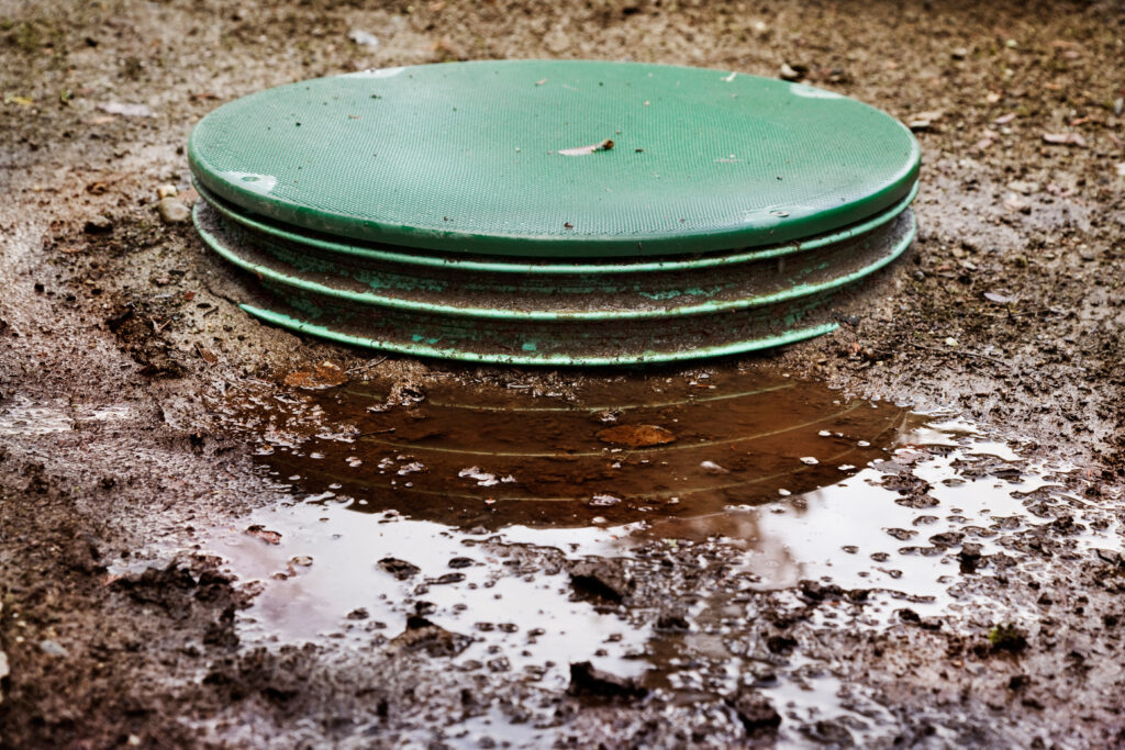 soggy ground around a septic drain field after heavy rain.