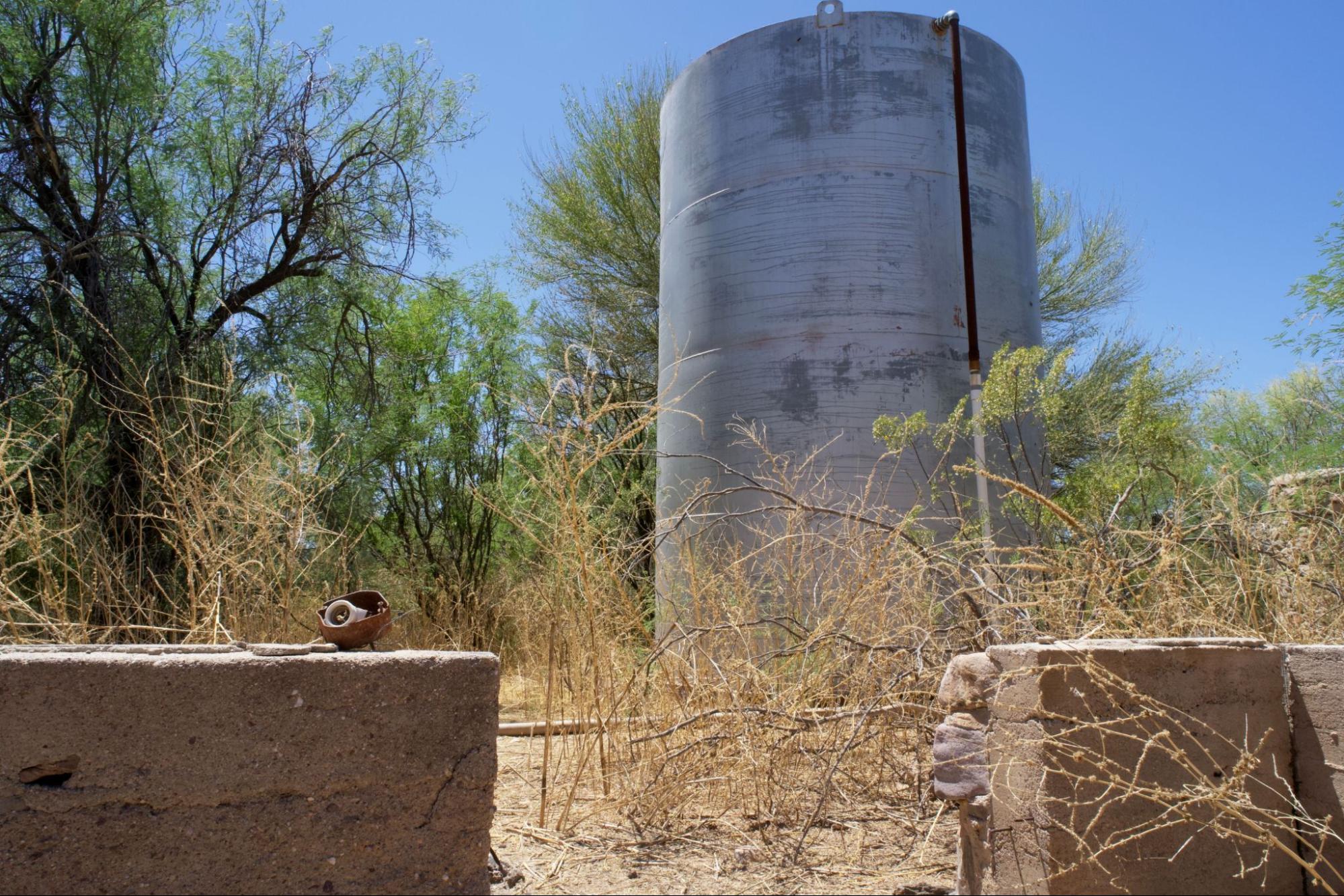 Steel water storage tank on a rural Northern Arizona property served by an onsite septic system.